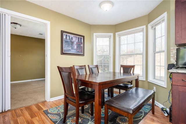 3090 Perch Ln SW, Marietta, GA 30008 - dining space featuring light wood finished floors, baseboards, and healthy amount of natural light