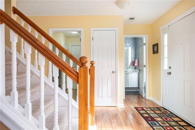 3090 Perch Ln SW, Marietta, GA 30008 - foyer entrance with light wood-style flooring, stairs, and baseboards