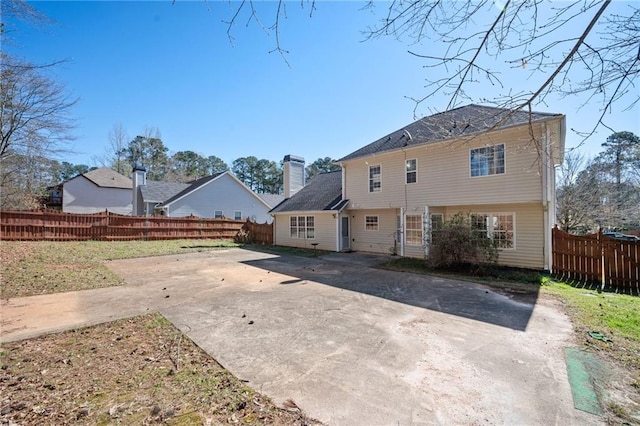 3090 Perch Ln SW, Marietta, GA 30008 - rear view of property with a fenced backyard, a patio area, a chimney, and driveway