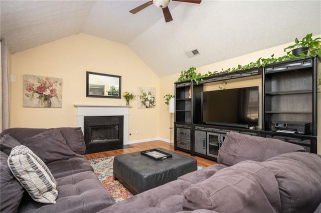 3090 Perch Ln SW, Marietta, GA 30008 - living room with a ceiling fan, baseboards, light wood finished floors, vaulted ceiling, and a textured ceiling