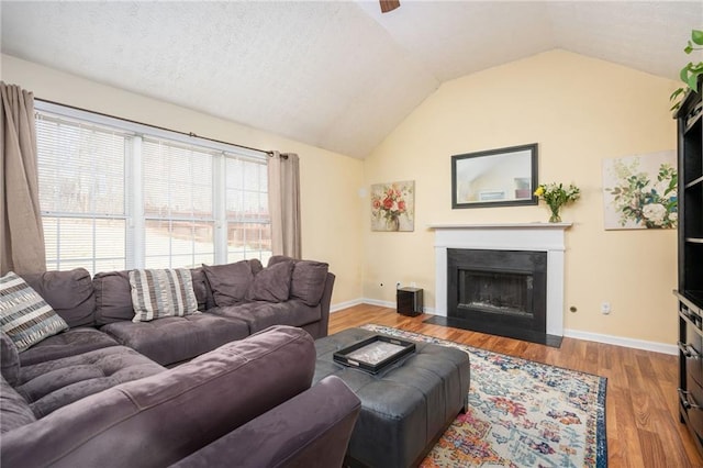 3090 Perch Ln SW, Marietta, GA 30008 - living area with vaulted ceiling, baseboards, wood finished floors, a fireplace with flush hearth, and ceiling fan