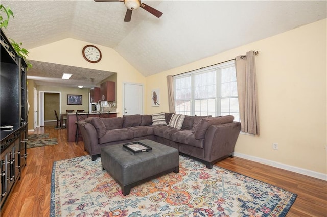 3090 Perch Ln SW, Marietta, GA 30008 - living area featuring ceiling fan, wood finished floors, vaulted ceiling, and baseboards