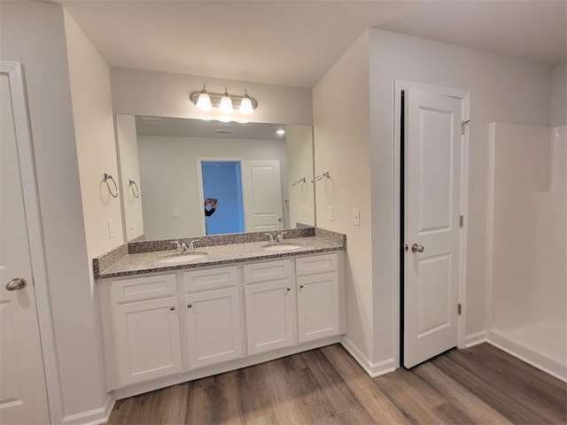 bathroom with vanity and hardwood / wood-style floors