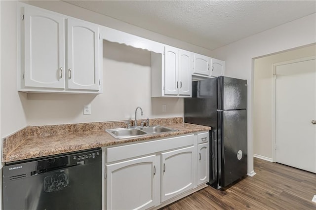 kitchen featuring sink, white cabinetry, a textured ceiling, hardwood / wood-style floors, and black appliances