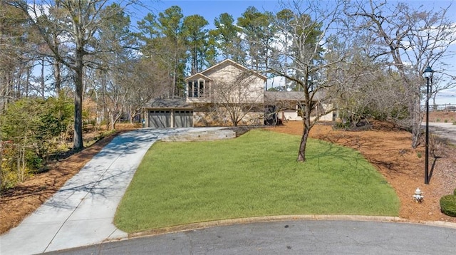 view of front of property featuring concrete driveway, a garage, and a front lawn