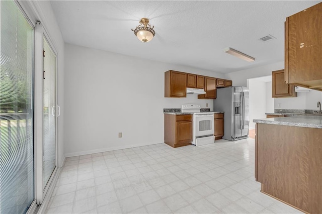 6440 Narramore Way, Lula, GA 30554 - kitchen featuring white range, stainless steel fridge with ice dispenser, under cabinet range hood, light floors, and light countertops