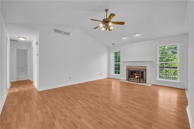 6440 Narramore Way, Lula, GA 30554 - unfurnished living room featuring plenty of natural light, ceiling fan, a lit fireplace, light wood-style flooring, and lofted ceiling