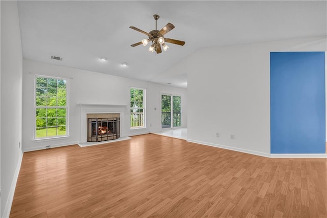 6440 Narramore Way, Lula, GA 30554 - unfurnished living room with ceiling fan, a warm lit fireplace, light wood-type flooring, lofted ceiling, and healthy amount of natural light