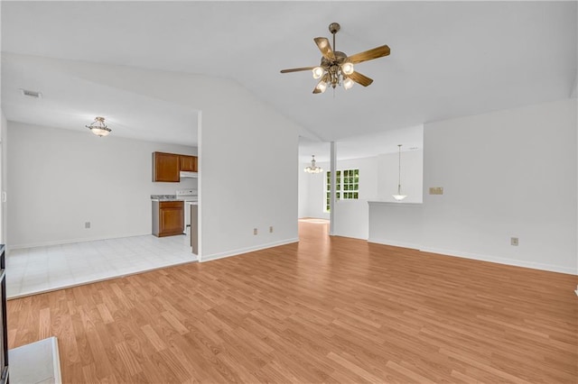 6440 Narramore Way, Lula, GA 30554 - unfurnished living room with ceiling fan, light wood-style flooring, vaulted ceiling, a chandelier, and baseboards
