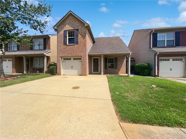 view of front property with a garage, a front yard, and covered porch