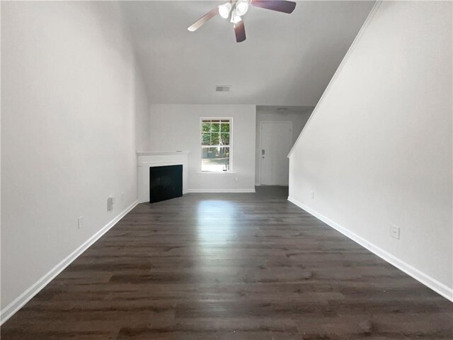 unfurnished living room with dark wood-type flooring and ceiling fan