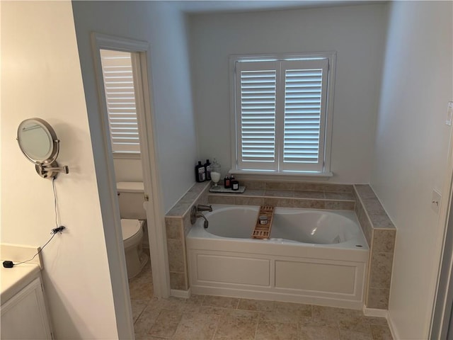 full bathroom featuring a bath and toilet