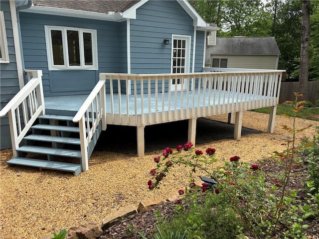 rear view of property with fence, a shingled roof, and a deck