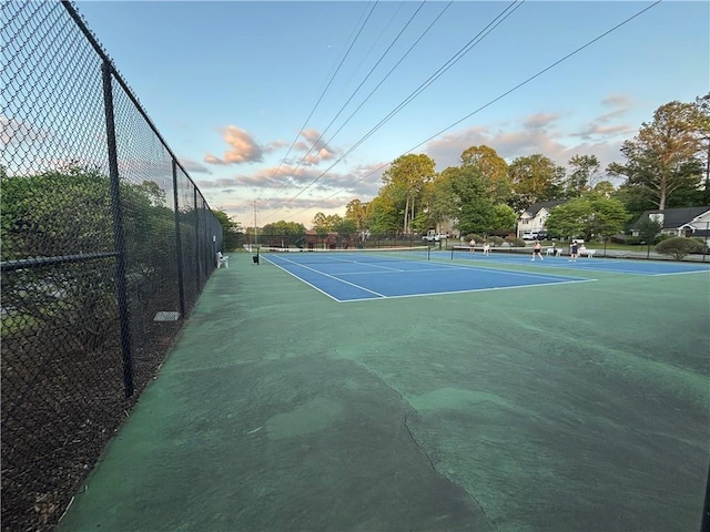 view of sport court featuring fence