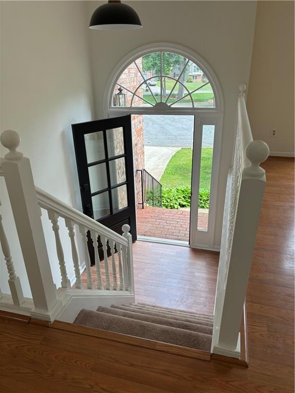 foyer featuring stairs and wood finished floors