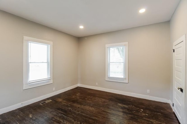 unfurnished room with dark hardwood / wood-style floors