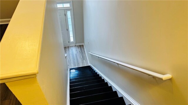 stairs featuring hardwood / wood-style floors