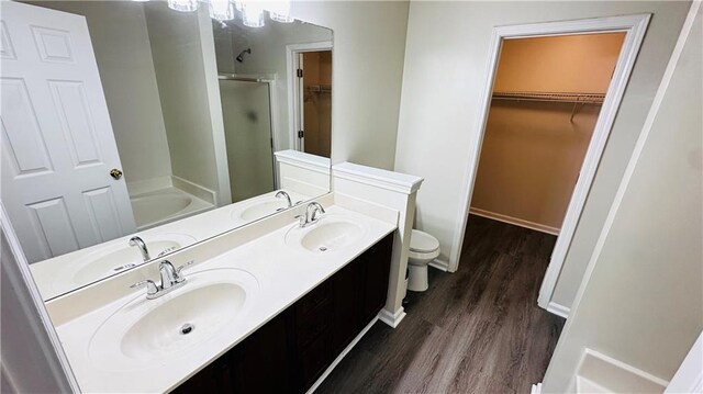 full bathroom with separate shower and tub, toilet, vanity, and hardwood / wood-style flooring