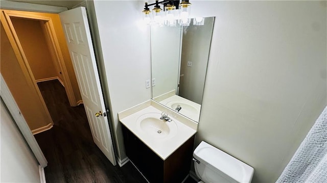 bathroom featuring hardwood / wood-style floors, vanity, and toilet