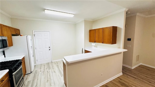 kitchen with range with gas stovetop, light hardwood / wood-style floors, white fridge with ice dispenser, and sink