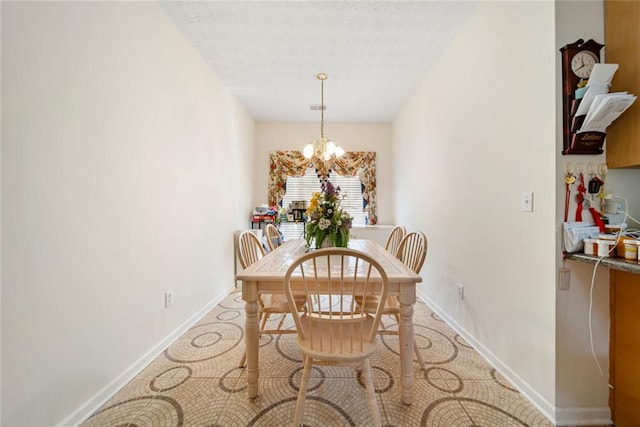 dining space featuring visible vents, a textured ceiling, baseboards, and an inviting chandelier