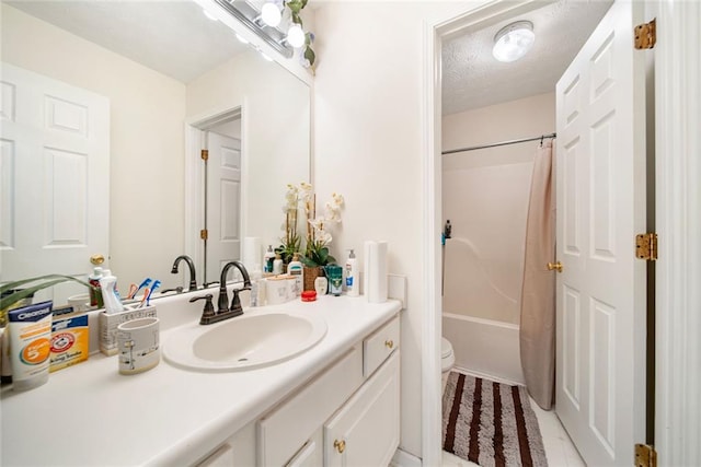 full bathroom with shower / bath combo, toilet, tile patterned floors, a textured ceiling, and vanity