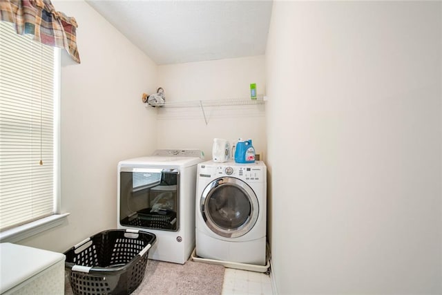 laundry area with laundry area, separate washer and dryer, and tile patterned floors