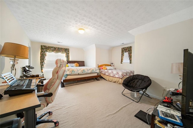 bedroom featuring carpet floors and a textured ceiling