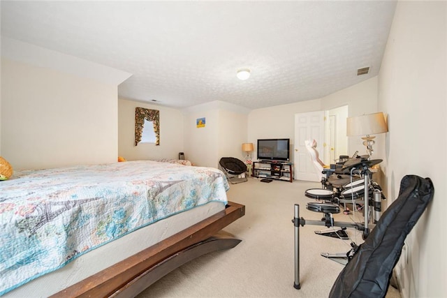 carpeted bedroom featuring visible vents and a textured ceiling