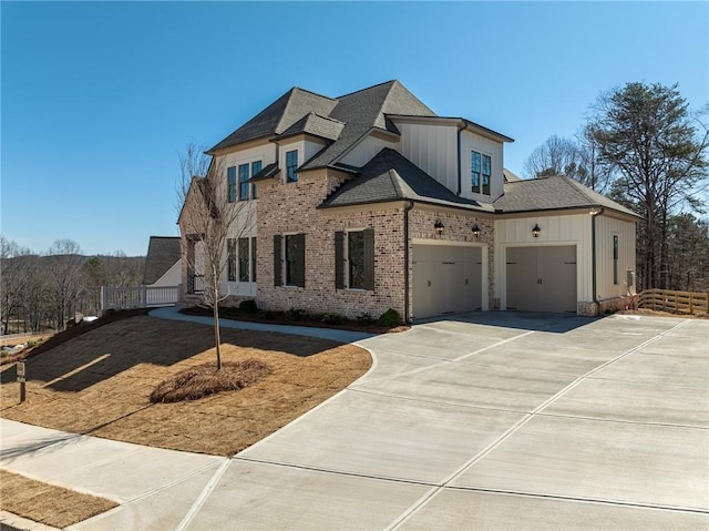 318 Reese Way, Ball Ground, GA 30107 - view of front of property featuring board and batten siding, concrete driveway, a shingled roof, brick siding, and an attached garage