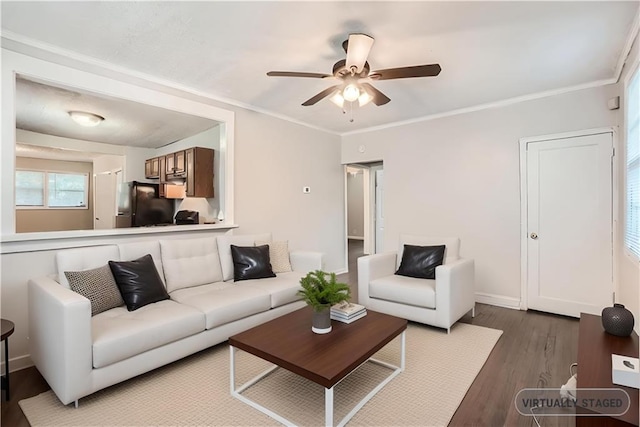 living area with ceiling fan, dark wood-type flooring, baseboards, and crown molding