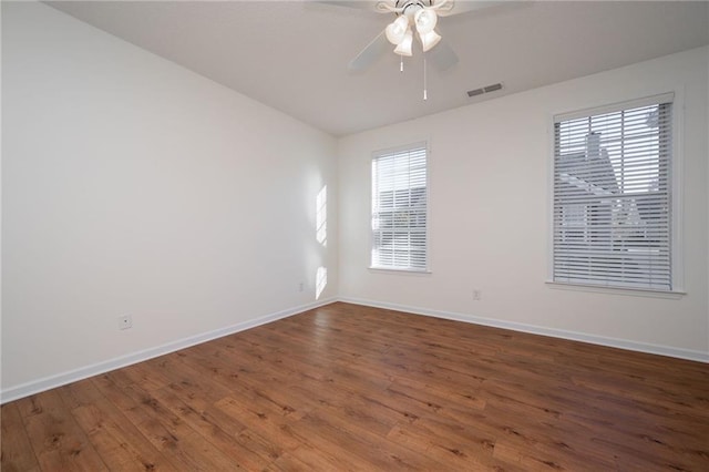 unfurnished room with hardwood / wood-style floors, ceiling fan, and a healthy amount of sunlight