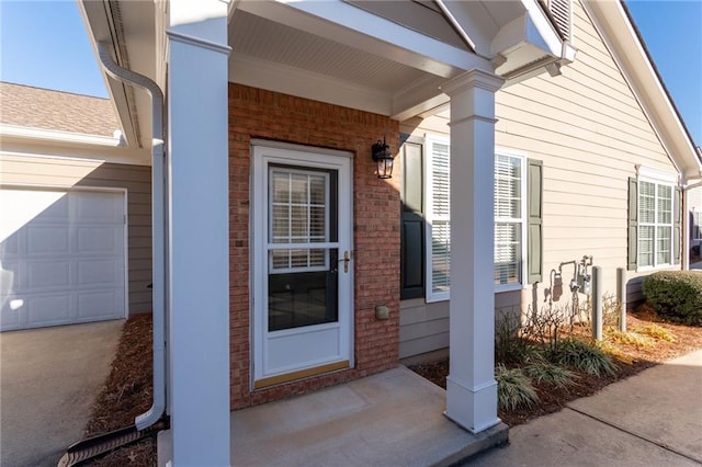 view of exterior entry with a garage