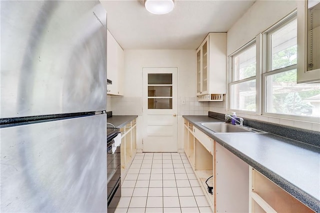 3221 Colquitt Dr, Atlanta, GA 30340 - kitchen featuring a sink, stove, freestanding refrigerator, light tile patterned floors, and tasteful backsplash