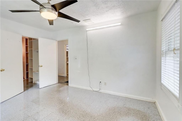 3221 Colquitt Dr, Atlanta, GA 30340 - unfurnished bedroom with visible vents, baseboards, a textured ceiling, speckled floor, and a ceiling fan