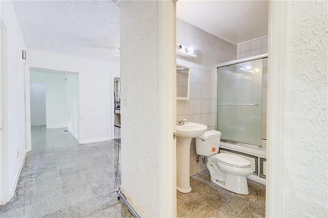 3221 Colquitt Dr, Atlanta, GA 30340 - bathroom featuring shower / bath combination with glass door, a sink, toilet, and tile walls