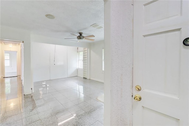 3221 Colquitt Dr, Atlanta, GA 30340 - empty room with visible vents, ceiling fan, a healthy amount of sunlight, and granite finish floor