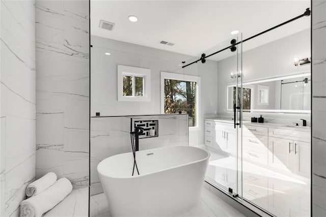 270 Boulder Dr, Roswell, GA 30075 - full bath featuring marble tiled floors, vanity, a freestanding bath, recessed lighting, and a marble finish shower
