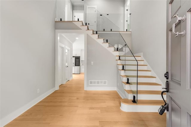 270 Boulder Dr, Roswell, GA 30075 - foyer with baseboards, stairway, light wood-style floors, and a high ceiling