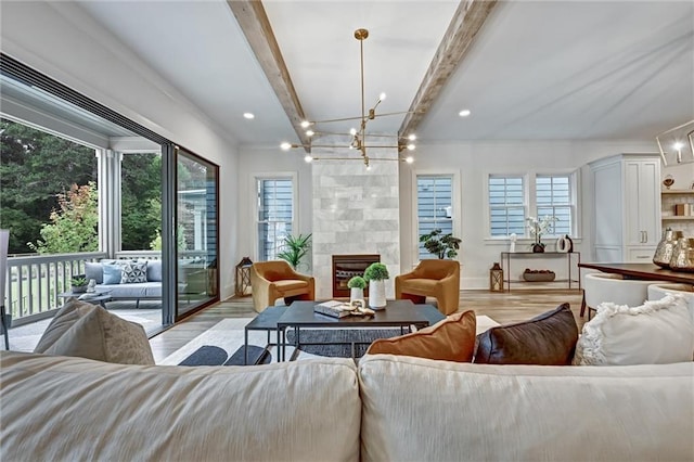 sunroom with beam ceiling, plenty of natural light, and a tiled fireplace