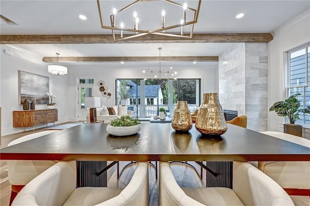 dining area featuring plenty of natural light, beamed ceiling, and an inviting chandelier