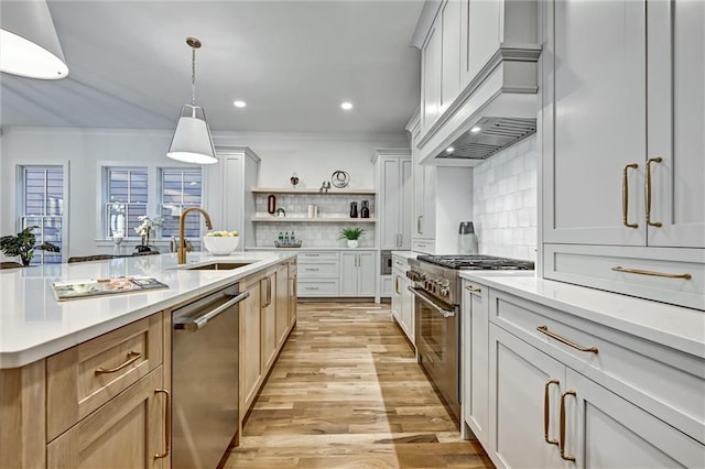 kitchen with pendant lighting, white cabinetry, sink, and appliances with stainless steel finishes