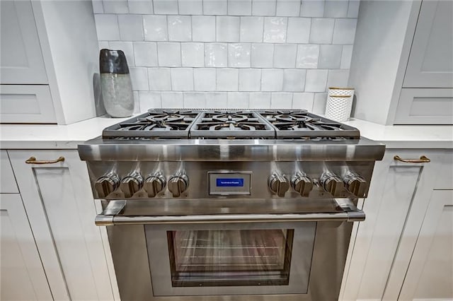 room details featuring backsplash and double oven range