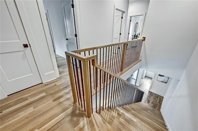 stairs featuring hardwood / wood-style floors