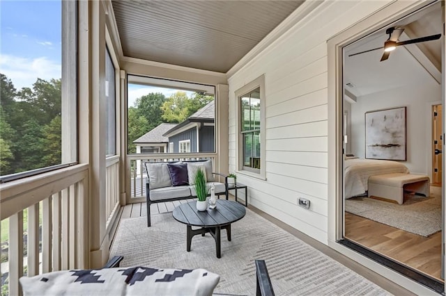 sunroom / solarium with ceiling fan and a healthy amount of sunlight