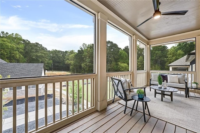 sunroom / solarium featuring ceiling fan