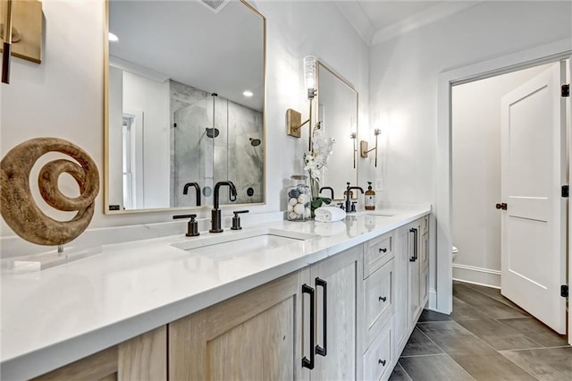 bathroom with vanity, toilet, ornamental molding, and walk in shower