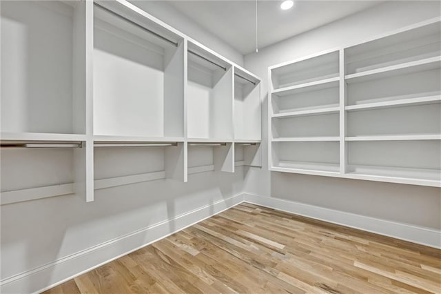 spacious closet featuring hardwood / wood-style flooring