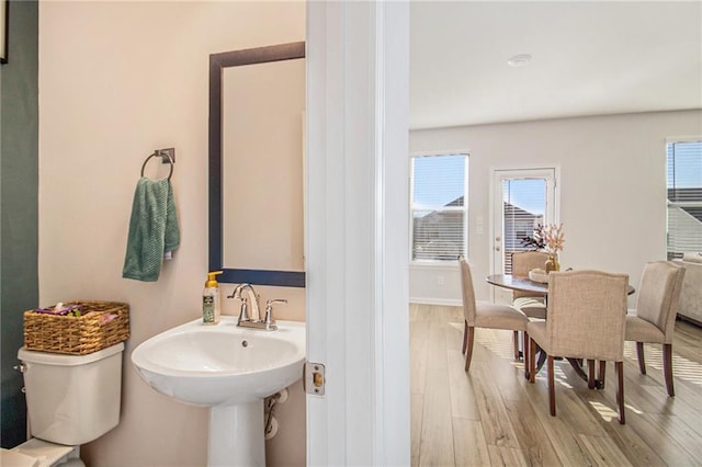 bathroom featuring hardwood / wood-style flooring and toilet