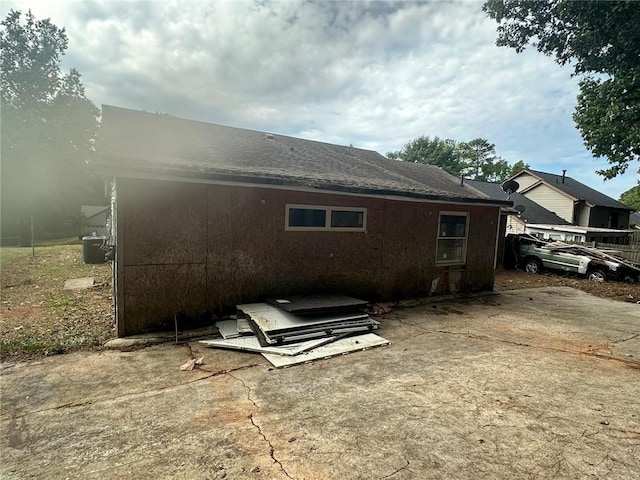 rear view of property featuring central AC